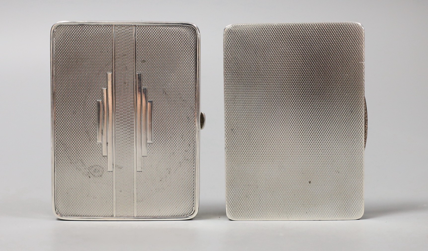 An Art Deco engine turned silver cigarette case, Crisford & Norris, Birmingham, 1934, 81mm and one other silver case.
